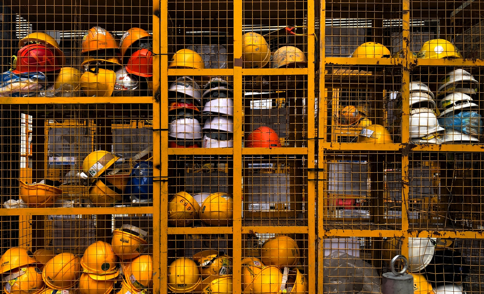 a rack filled with lots of yellow hard hats, insurance